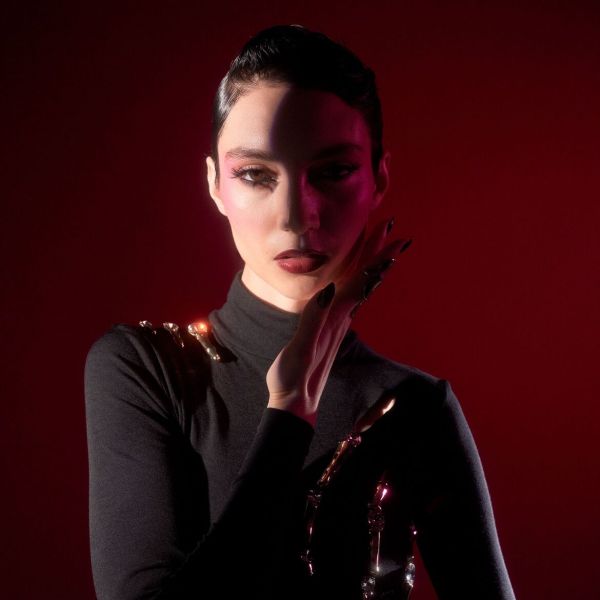 Musta kleidi ja erksa meigiga naise portree punasel taustal